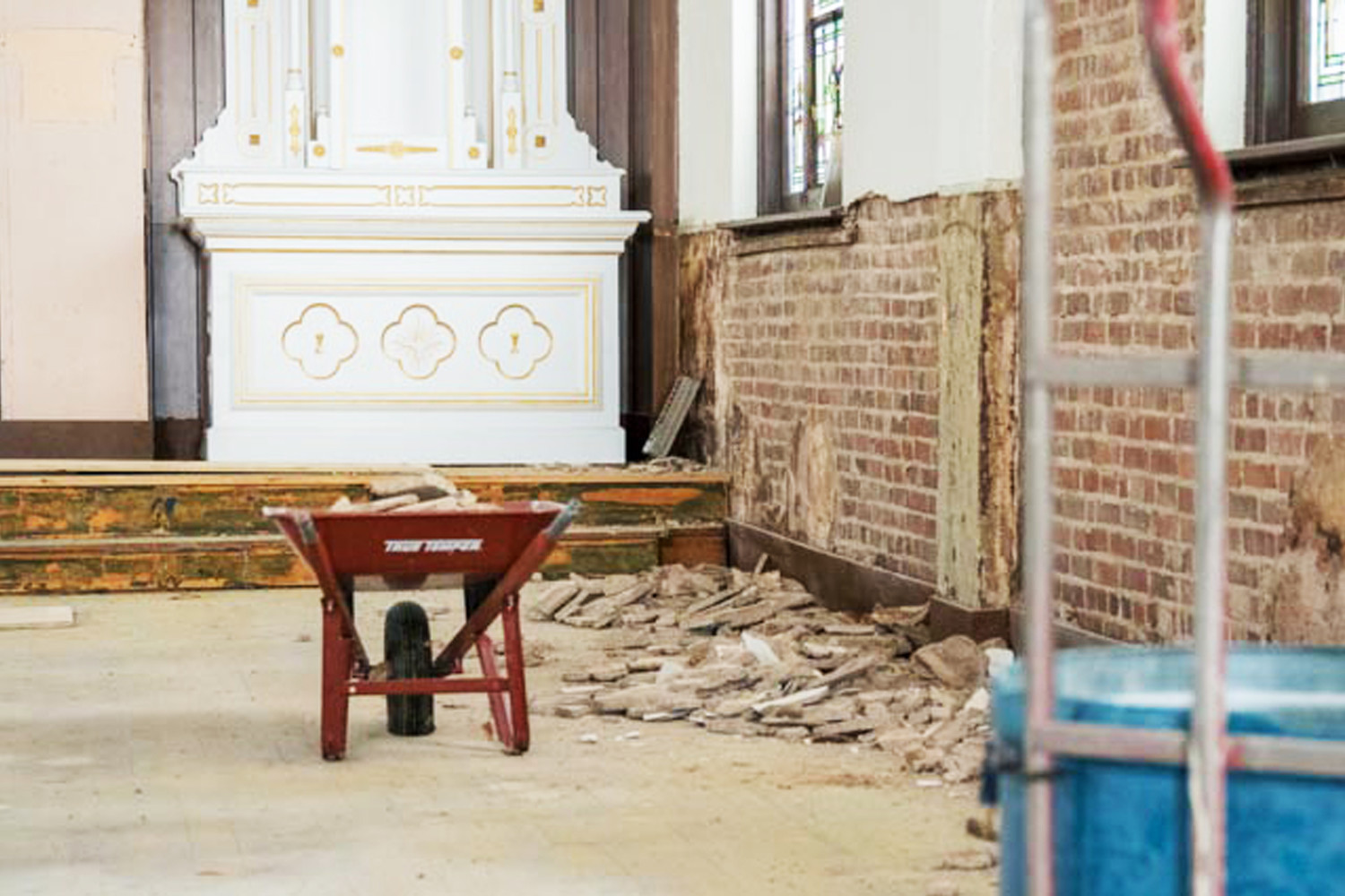 The removal of old wood paneling and plaster revealed the solid brickwork of the 1923-vintage church building.